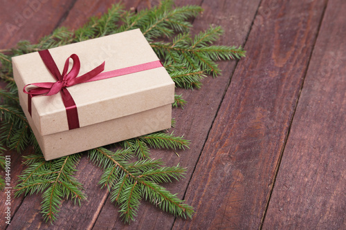 Christmas fir tree with gift boxe on wooden board