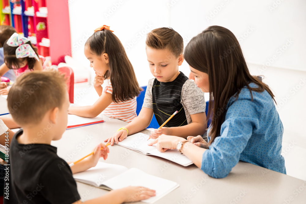 Teacher explaining assigment to pupil Teacher explaining assigment to pupil