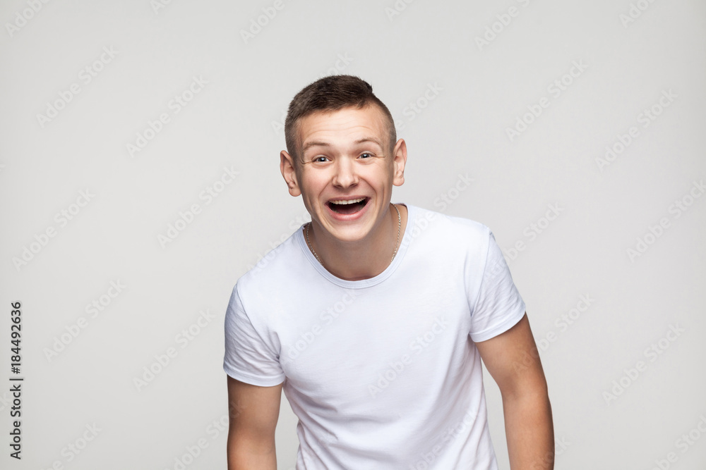 Young success man looking at camera and toothy smile. Young success man looking at camera and toothy smile.