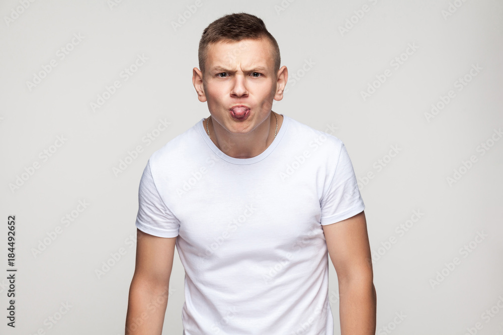 Close up tongue out. Portrait of funny young man. Close up tongue out. Portrait of funny young man.