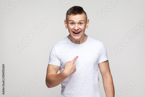 Happiness boy looking at camera and pointing finger himself.