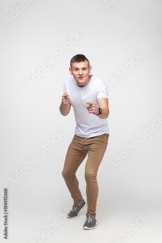 Emotional boy pointing finger at camera