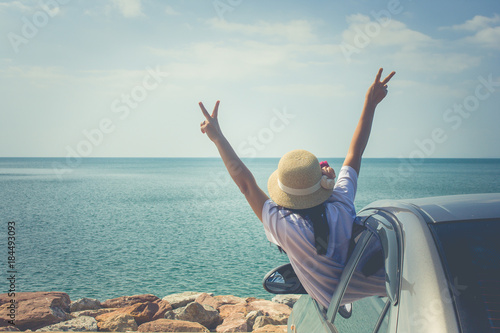 Vacation and Holiday Concept : Happy family car trip at the sea, Portrait woman feeling happiness in silver car. photo