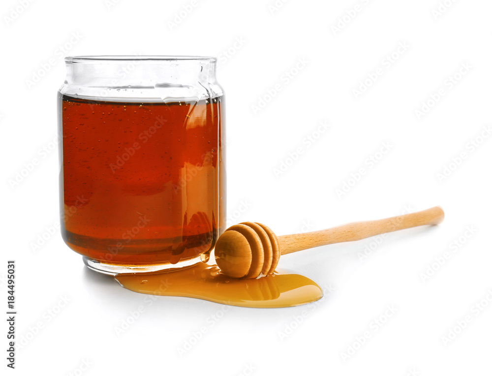 Jar of honey with dipper, isolated on white Jar of honey with dipper, isolated on white