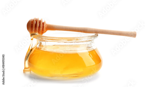 Jar of honey with dipper, isolated on white