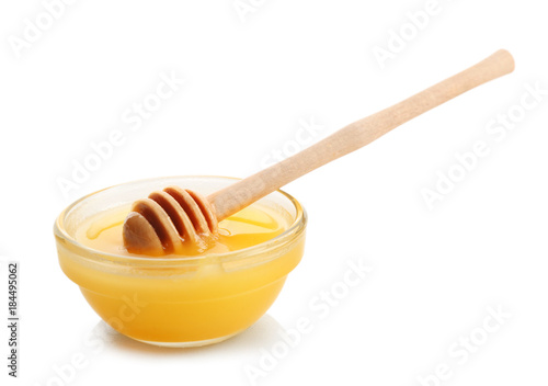 Bowl of aromatic honey with dipper, isolated on white