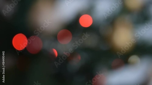 Horizontal fast pan of blinking red bokeh lights on a Christmas tree.