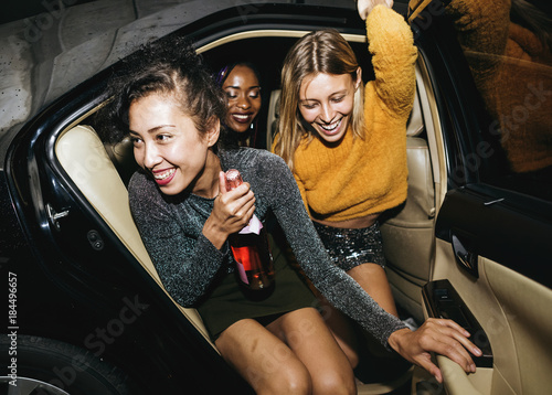 Fotografie Diverse women in a backseat of a cab