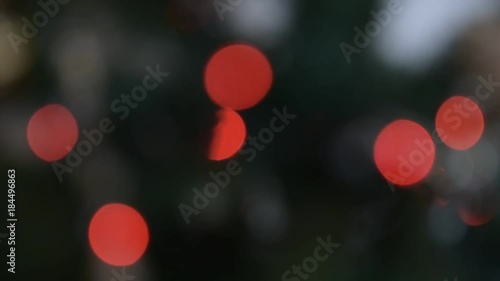 Red bokeh blinking lights on a Christmas tree