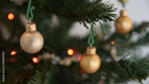 Details of Christmas tree with white balls and red blinking lights (focus change)