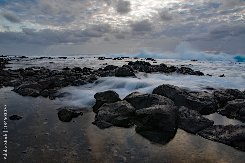 Long exposure of waves falling over weathered rocks at Sandy beach, Oahu, Hawaii Long exposure of waves falling over weathered rocks at Sandy beach, Oahu, Hawaii
