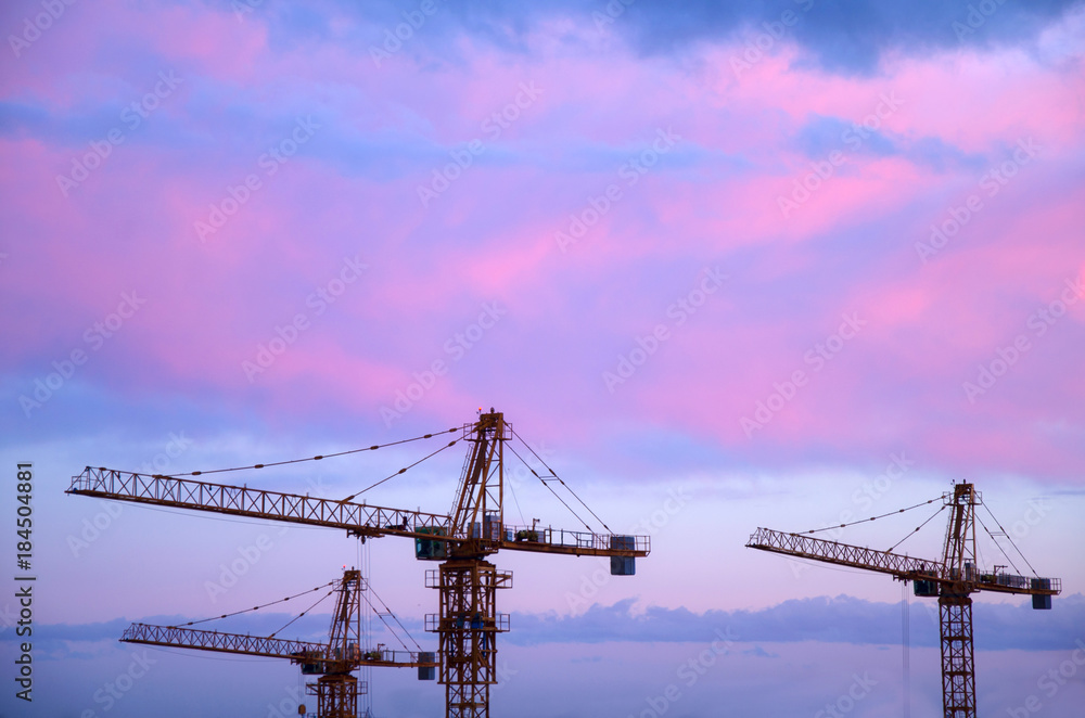 three construction crane on sky background