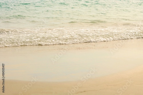 Small waves on the beach at afternoon, soft wave of the sea on the sandy beach, selective focus