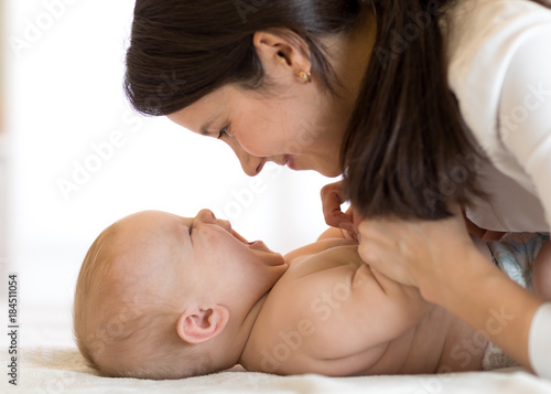 happy mother playing with n...