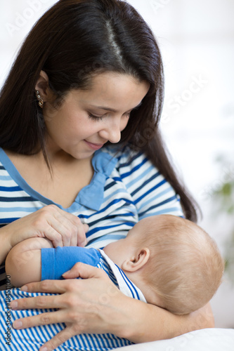 Baby feeds on mother's brea...
