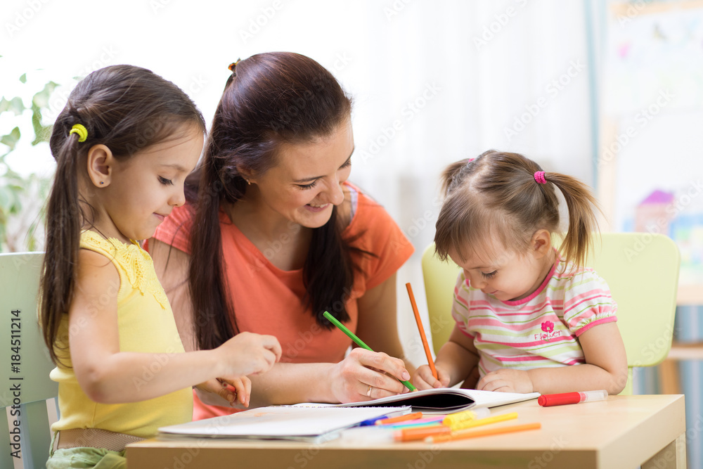 Teacher mom working with creative kids Teacher mom working with creative kids