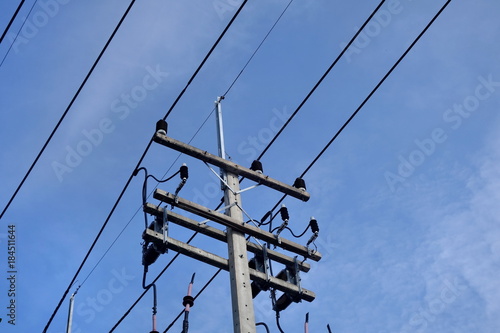 electricity cable and pole against blue sky