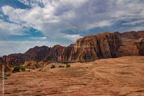 The Petrified sand dunes and amazing red Navajo sandstone mountains of Snow Canyon State Park in Southern Utah.