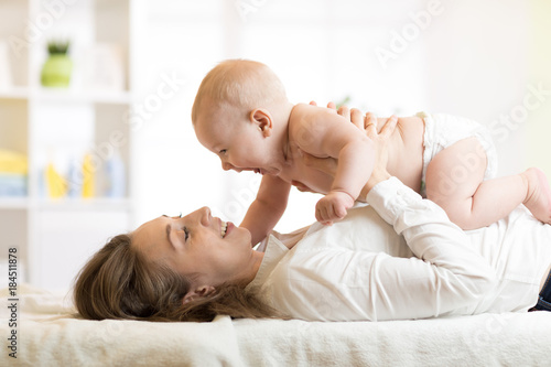 happy mother playing with n...