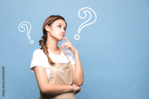 Fotografie young woman with question marks.