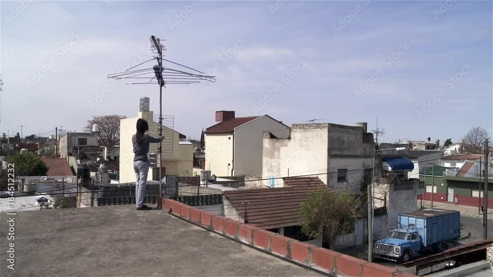 Woman on roof with television antenna Woman on roof with television antenna