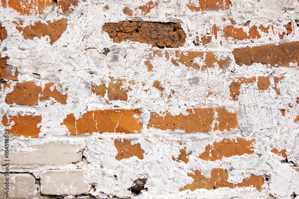 a wall of different colors bricks covered with lime a wall of different colors bricks covered with lime