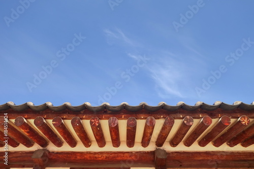 Traditional korean architecture roof with blue sky background. © gbaitong