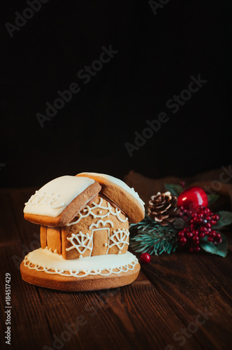 Traditional Christmas gingerbread house on rustic wooden background