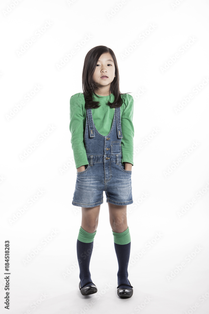 girl wearing green shirts, denim pants (kid) isolated on the white background.
