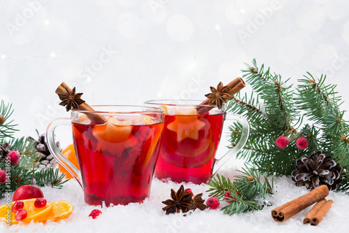 Christmas mulled wine and ingredients. On white snow background with copyspace