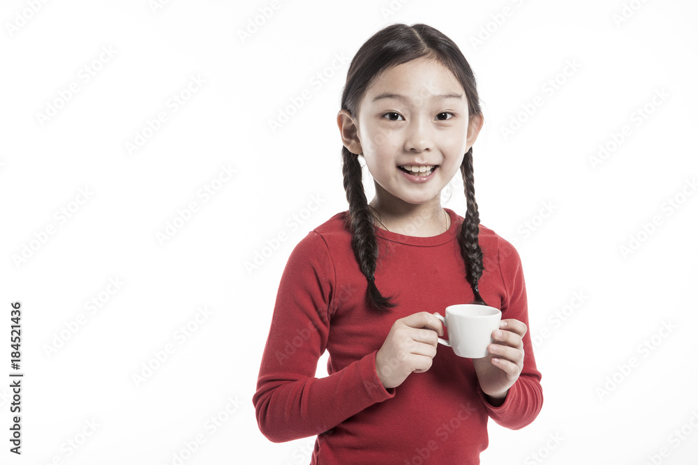 girl(kid) hand hold a tea cup isolated on the white background. girl(kid) hand hold a tea cup isolated on the white background.