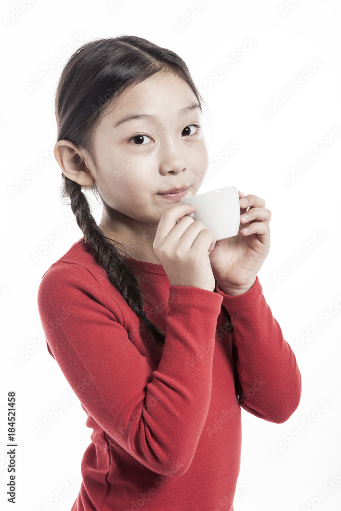 girl(kid) hand hold a tea cup isolated on the white background. girl(kid) hand hold a tea cup isolated on the white background.