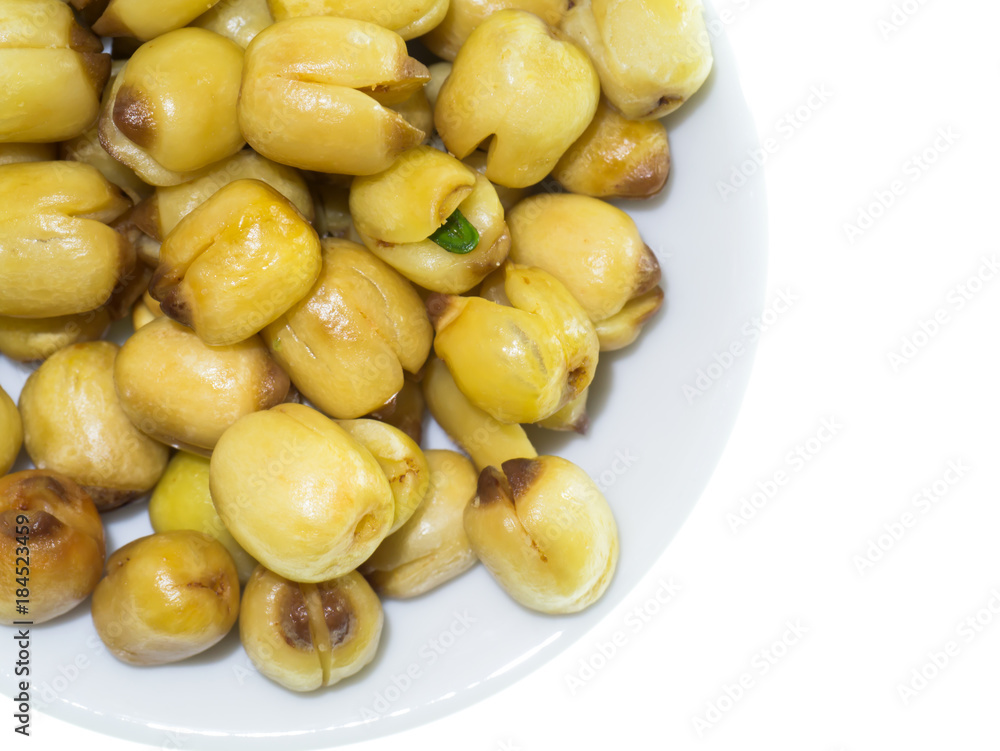 Lotus seeds roasted on white background. Lotus seeds roasted on white background.