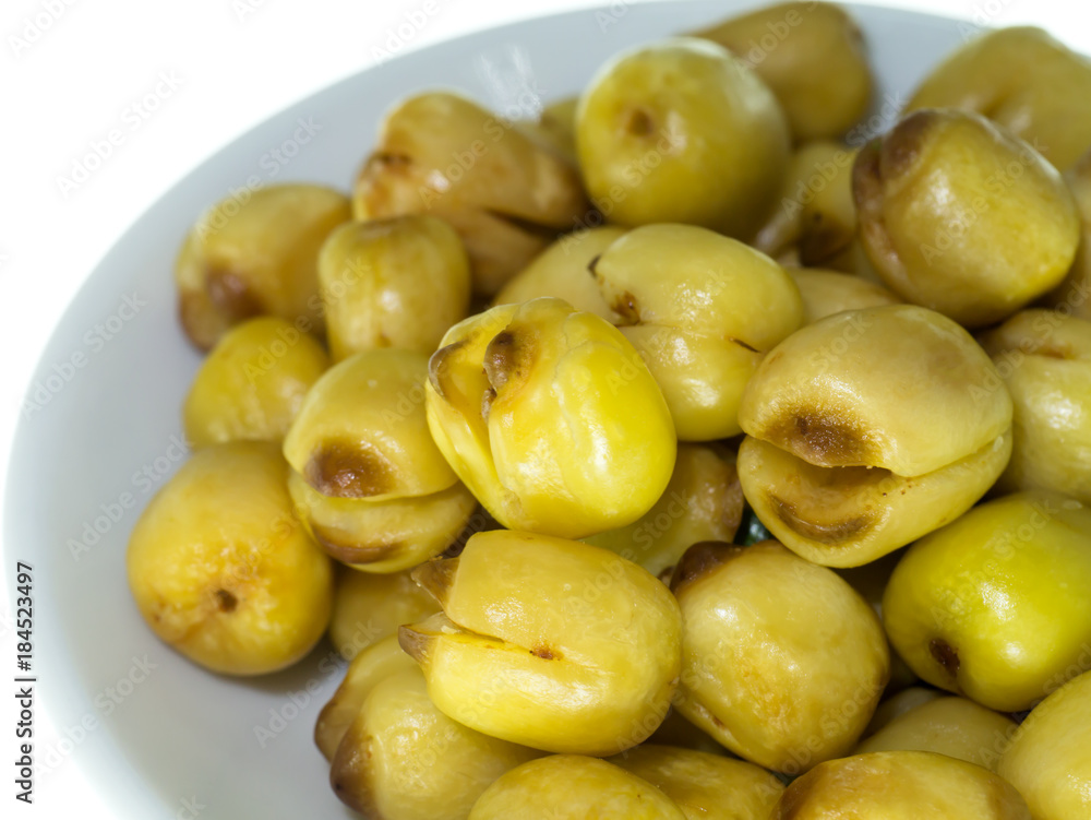 Lotus seeds roasted on white background. Lotus seeds roasted on white background.