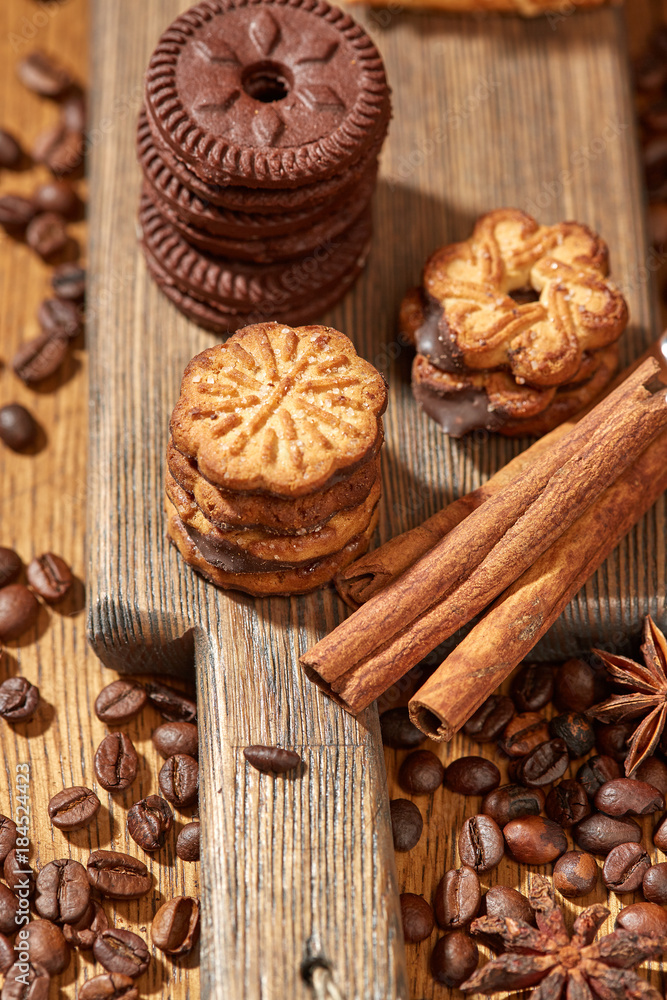 Aroma coffee candy chocolate cookies and spices on the wooden table. Christmas sweets. Dark wooden background. Top view. Close. Closeup. Aroma coffee candy chocolate cookies and spices on the wooden table. Christmas sweets. Dark wooden background. Top view. Close. Closeup.