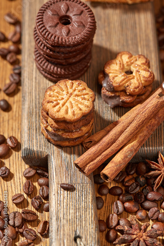 Aroma coffee candy chocolate cookies and spices on the wooden table. Christmas sweets. Dark wooden background. Top view. Close. Closeup.