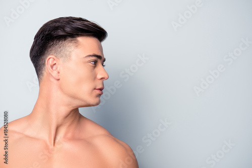 Fototapeta Profile side view half-faced close up portrait of confident handsome shaven with
