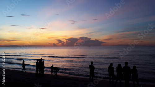 Silhouette of people taking picture of landscape during sunrise Scenic View Of Beach Against Sky During Sunset.