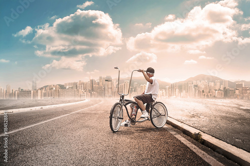 Man with bycicle far from the city