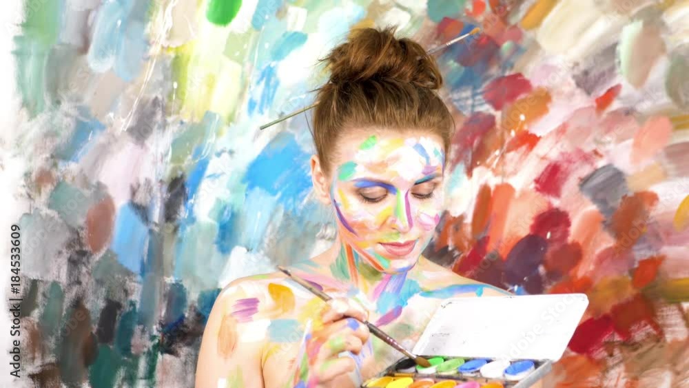 Artist Paints applying make up. Woman-Picture. Slow motion. Artist Paints applying make up. Woman-Picture. Slow motion.