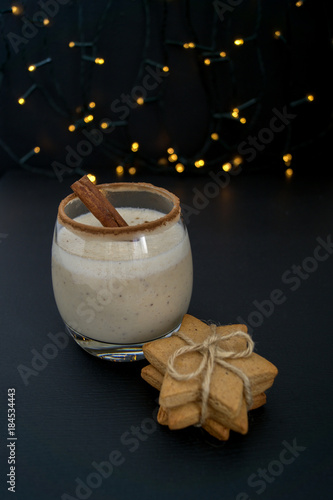 Cocktail eggnog and cookies are the stars on the background lights.