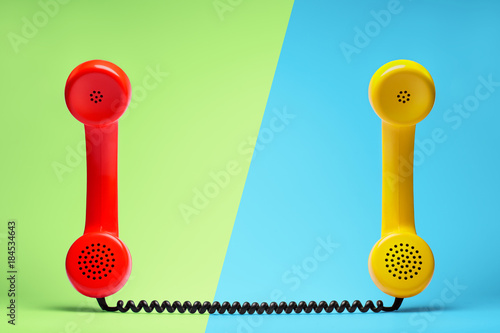 Red and yellow telephone in retro style.