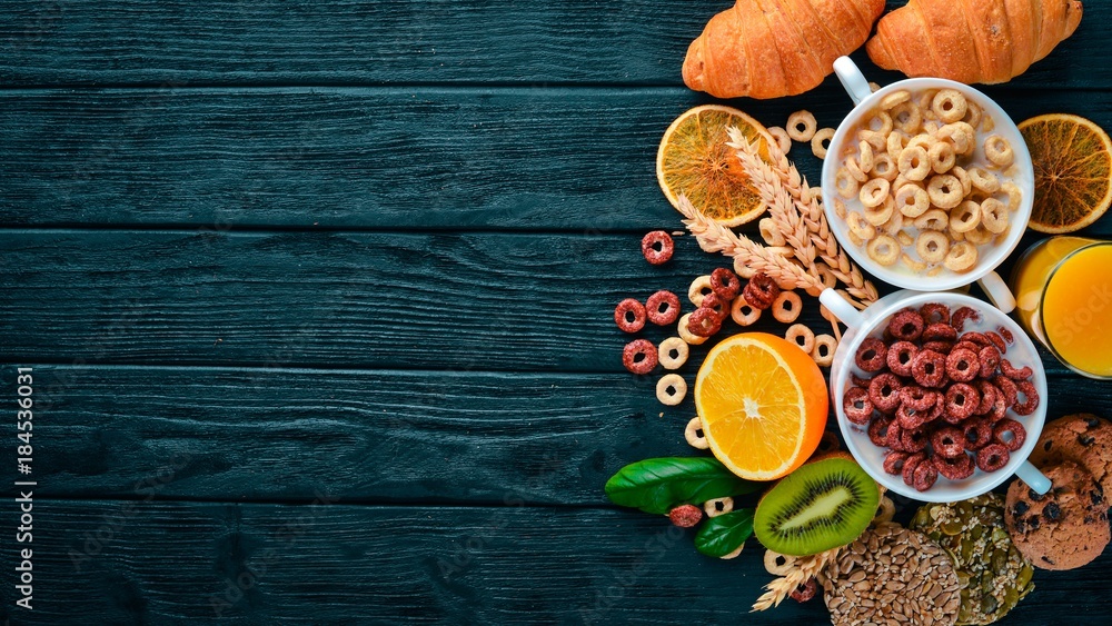 Fitness breakfast, muesli, milk, fruits, nuts and seeds, on a wooden surface. Top view. Free space for text. Fitness breakfast, muesli, milk, fruits, nuts and seeds, on a wooden surface. Top view. Free space for text.