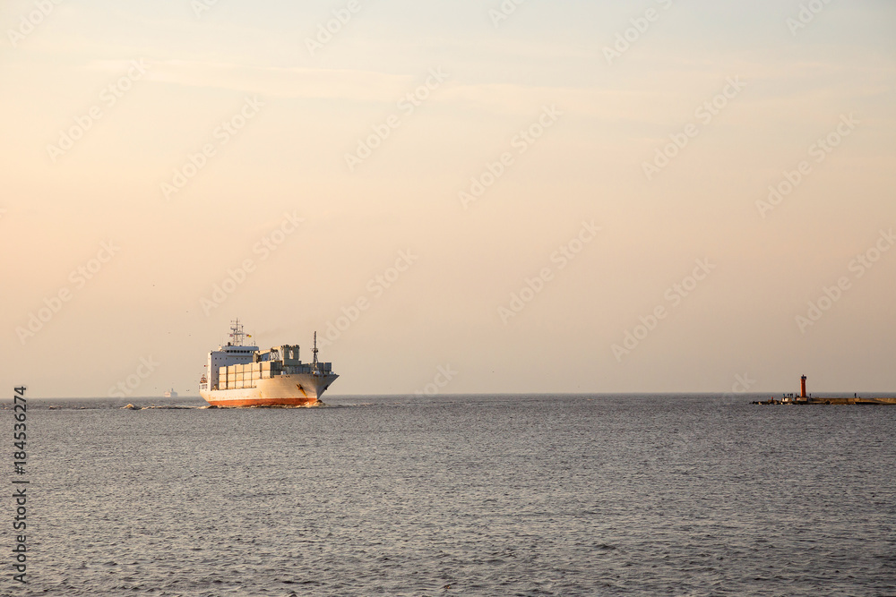 Not the big vessel with containers in the sunset sun. Not the big vessel with containers in the sunset sun.