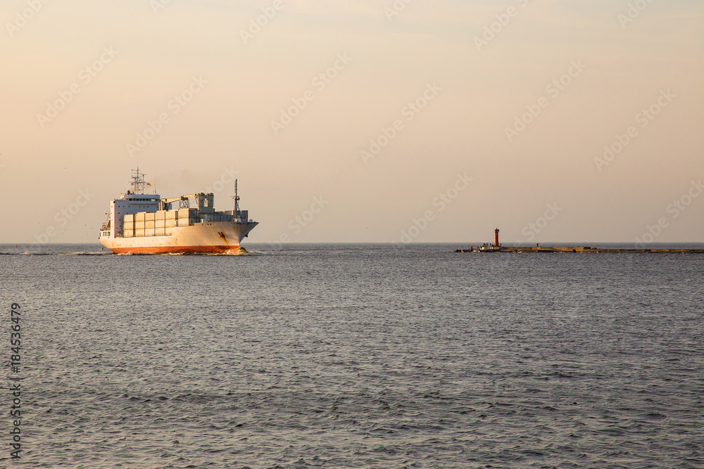 Not the big vessel with containers in the sunset sun.