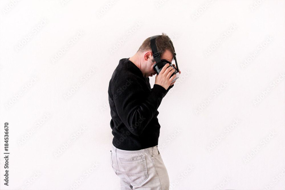 Handsome man wearing and playing virtual reality on isolated white background. Boy action in virtual reality helmet. VR glasses. VR Box, VR headset. Young business man at office and using Vr Box. Handsome man wearing and playing virtual reality on isolated white background. Boy action in virtual reality helmet. VR glasses. VR Box, VR headset. Young business man at office and using Vr Box.