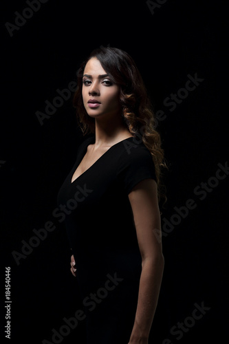 Beautiful woman with evening make-up in black dress