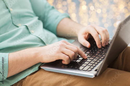 close up of man typing on laptop keyboard