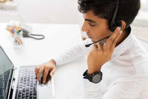 businessman with headset and laptop at office