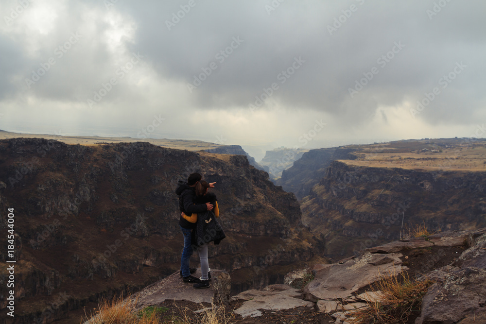 Couple standing on top of a rock in Armenia